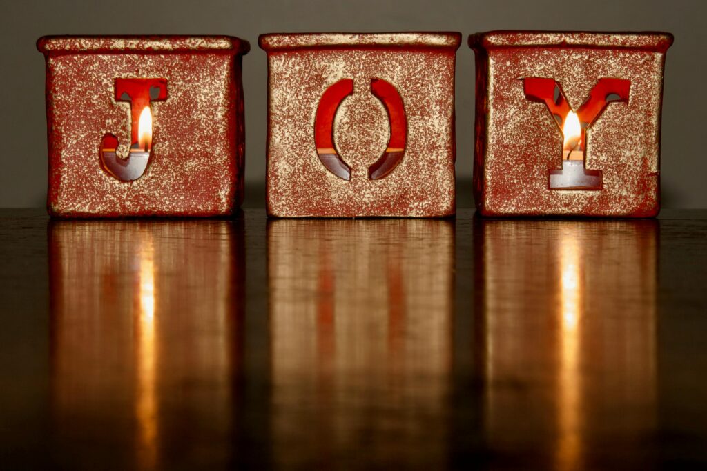 Three candlelit blocks spelling 
