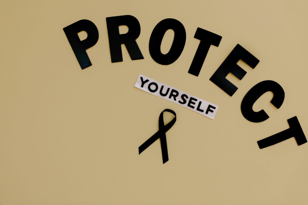 Black ribbon on yellow background with text advocating self-protection and awareness.